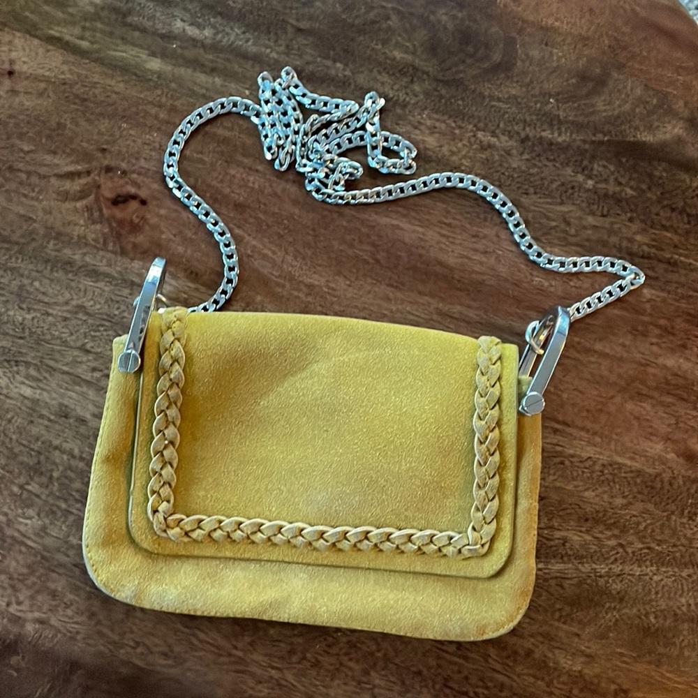 Mustard yellow suede purse with silver crossbody chain strap and braided detail